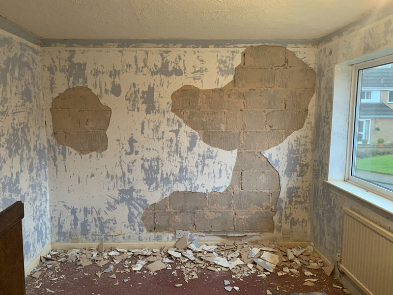 stripping plaster off walls
